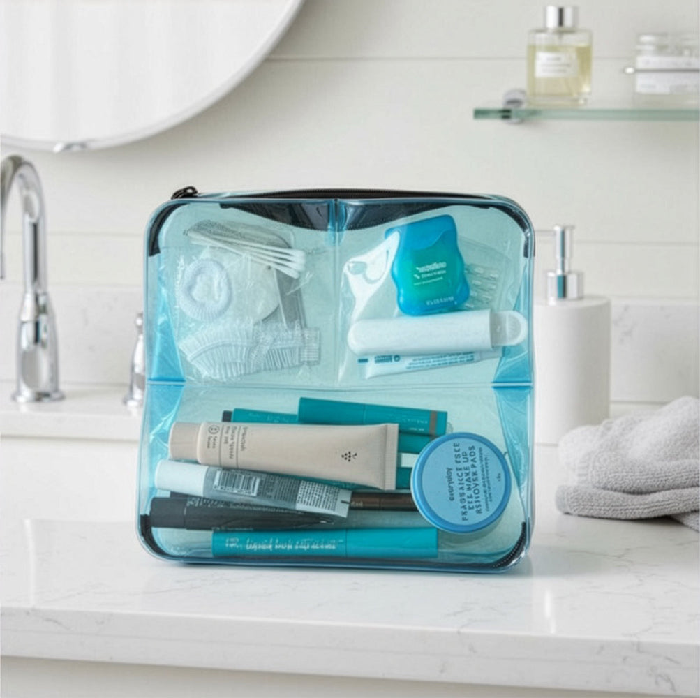 Blue DivideNPac organizer on a bathroom counter filled with travel toiletries — toothbrush, makeup, skincare, and small essentials.