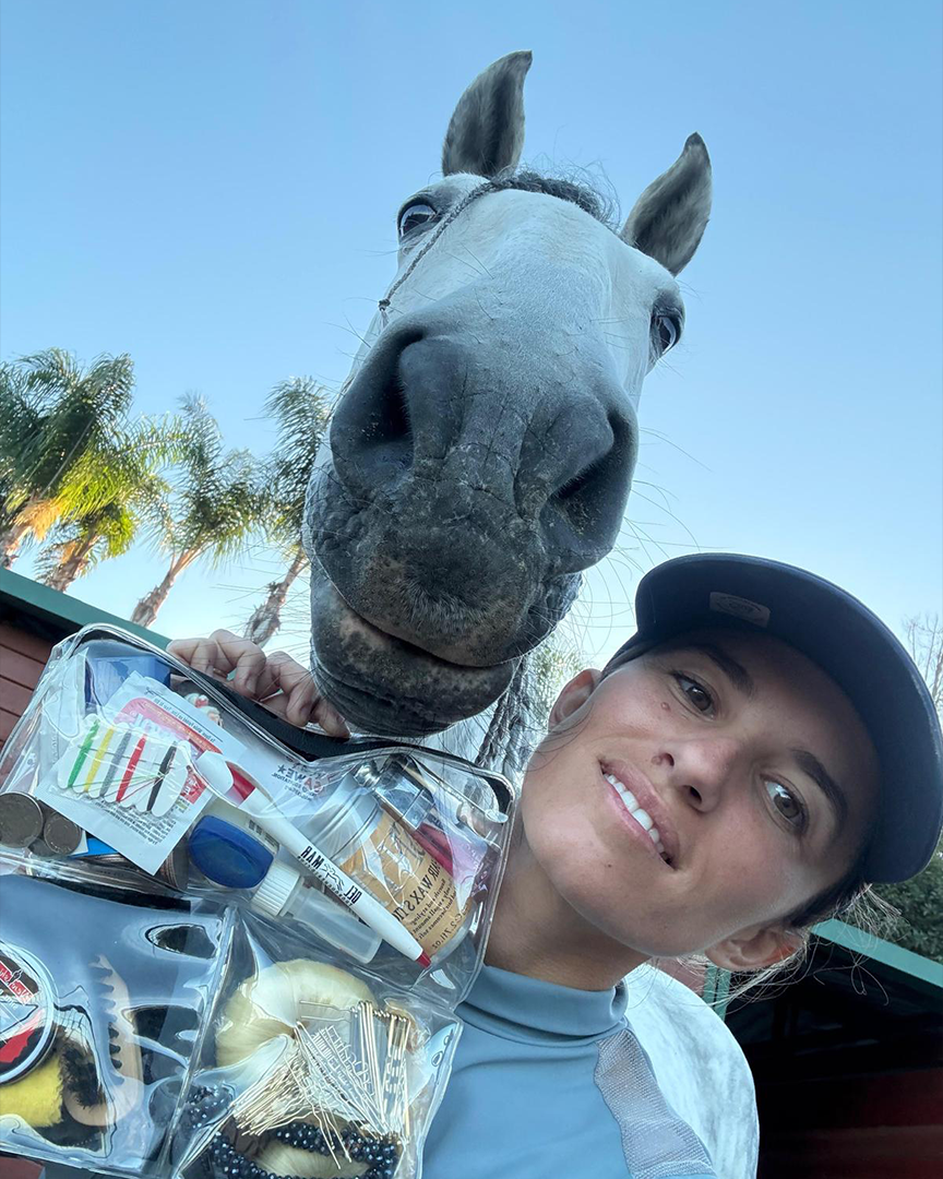 Customer with her horse holding a DivideNPac organizer packed with grooming and equestrian supplies.