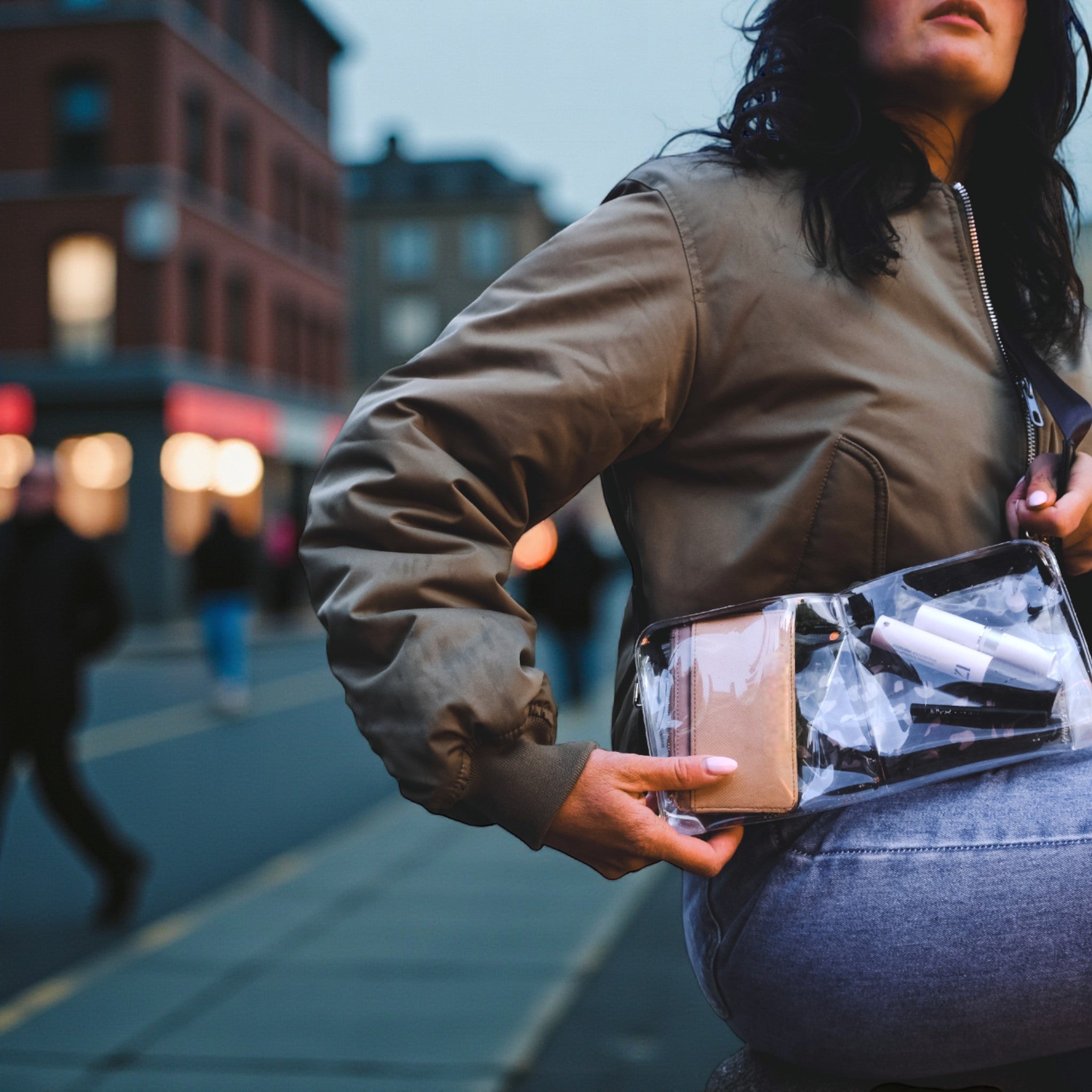 Woman wearing stadium approved clear bag crossbody style in city, stylish NFL compliant organizer